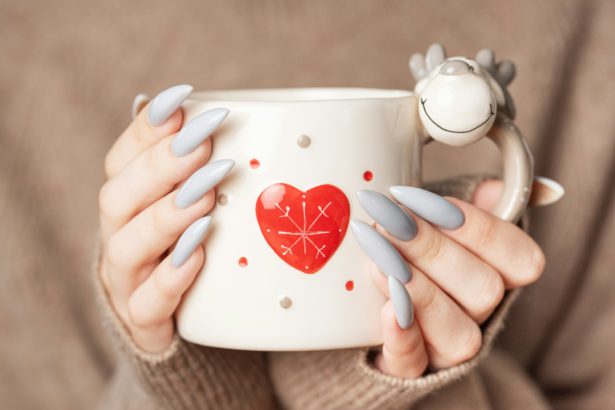 Close up of woman's hand with grey nail polish