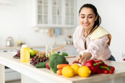 Healthy Food To Boost Your Immune System. Woman cooking salad